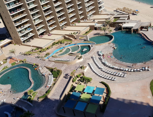 Great balcony views of the 4 diamond resort pools, swim-up bar and grille, lazy river, hammock area and heated spa!